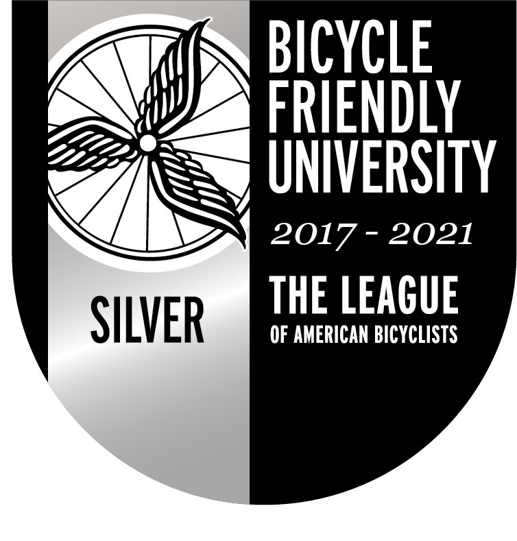 Bike Friendly University logo with a wheel on the left with a silver background and program language on the right